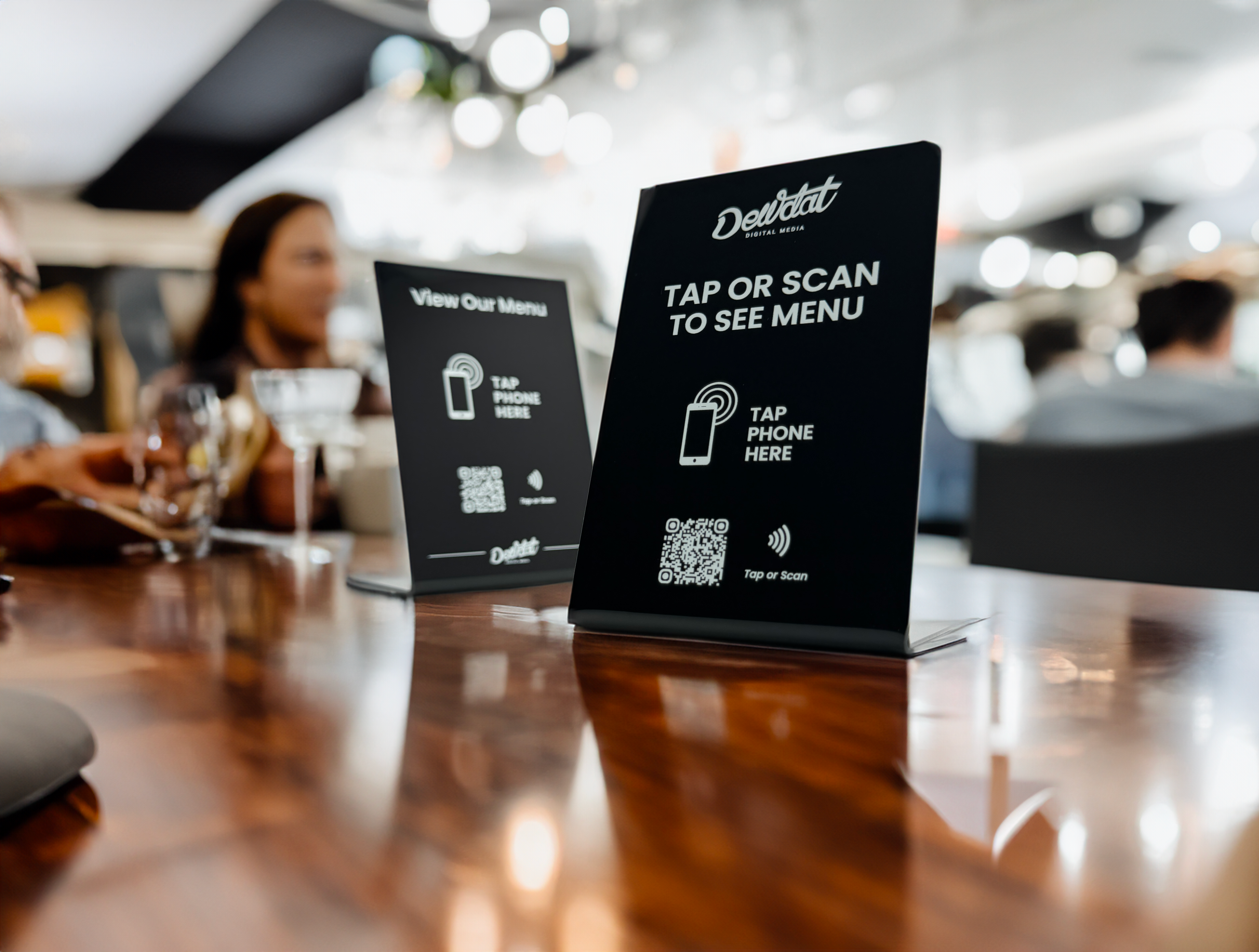 Two original Dewdat Tap Menu table stands in use at a restaurant